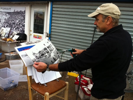 Charles Denson washes damaged photograph